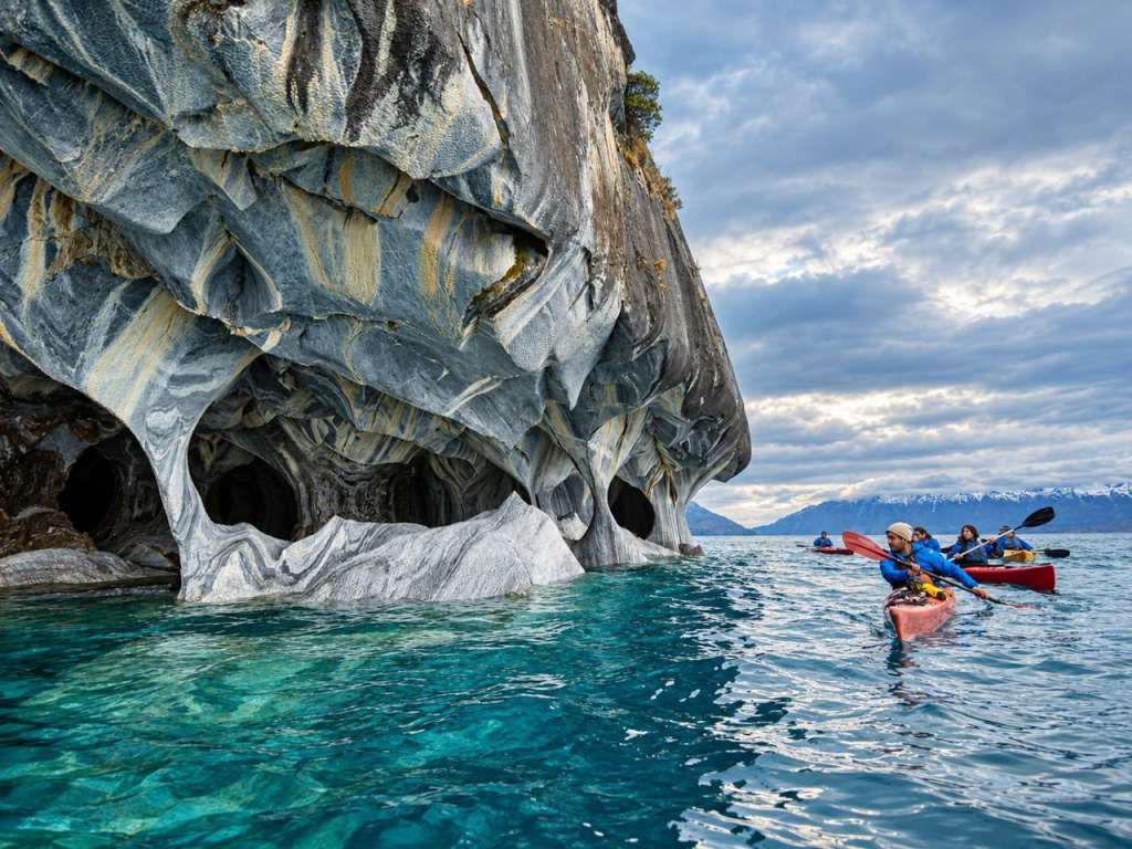 Kayakers paddling beneath the Marble Caves on General Carrera Lake