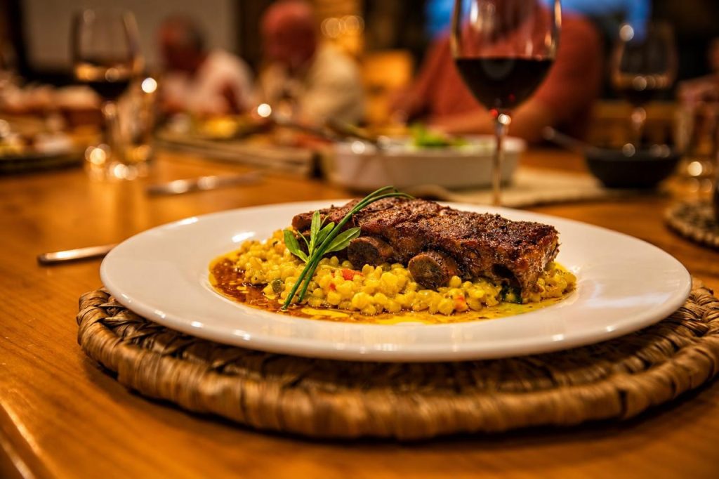 Patagonian lamb with saffron rice and a glass of red wine