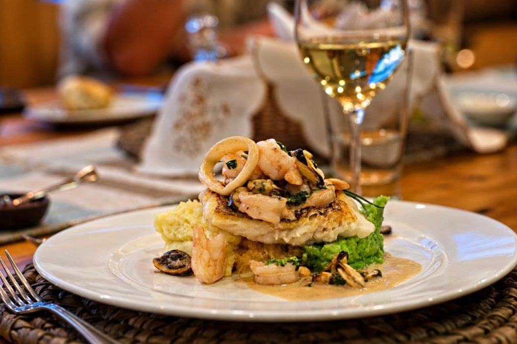 Fresh fish with seafood and a glass of white wine